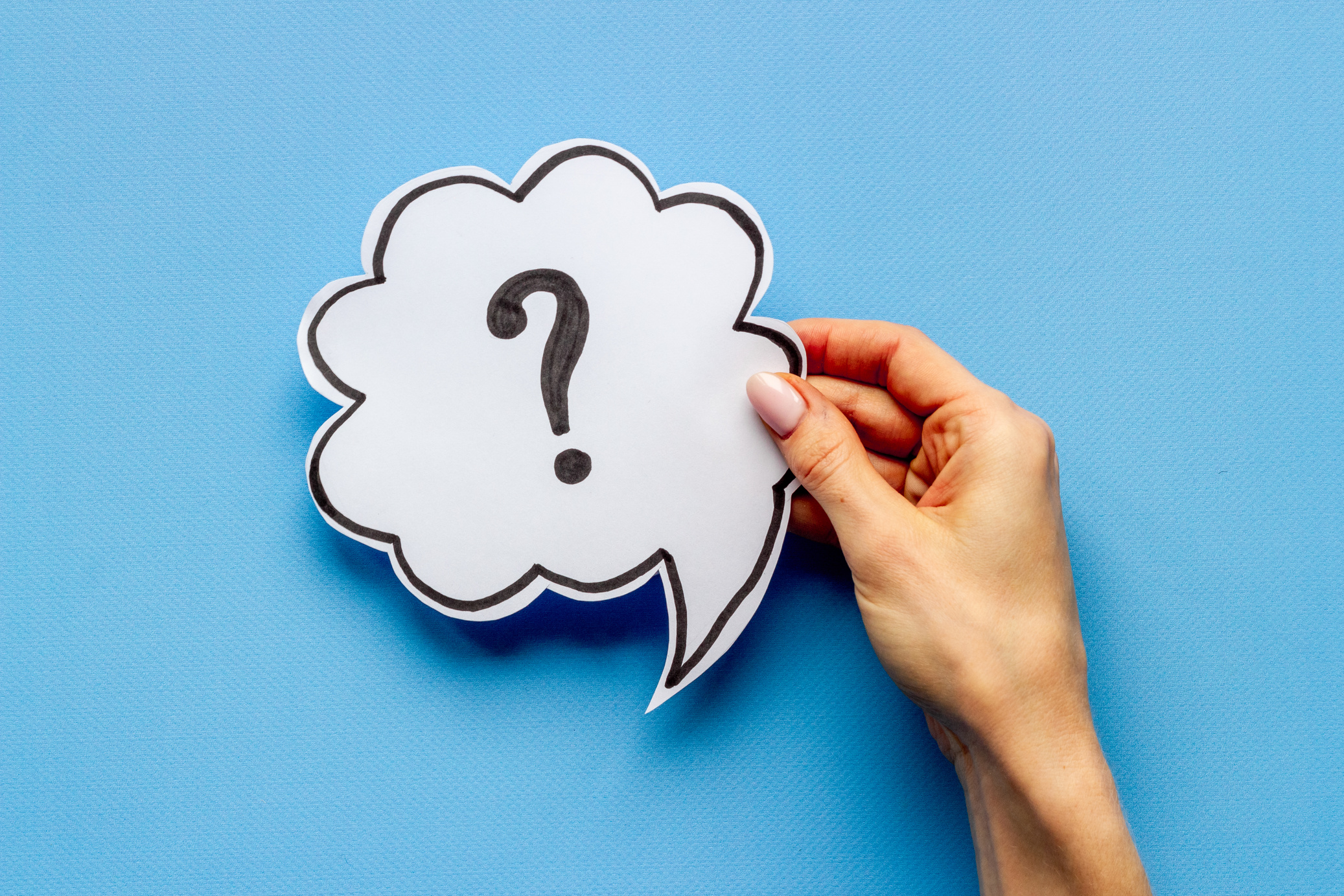 Question mark on speech bubble in hands. FAQ or search information